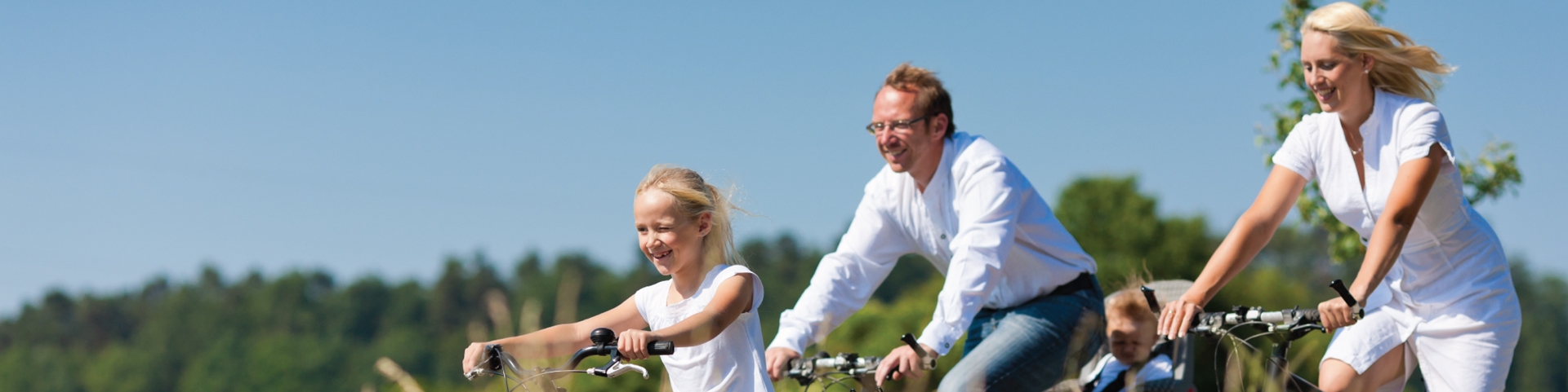 A family riding their bikes together during a sunny day