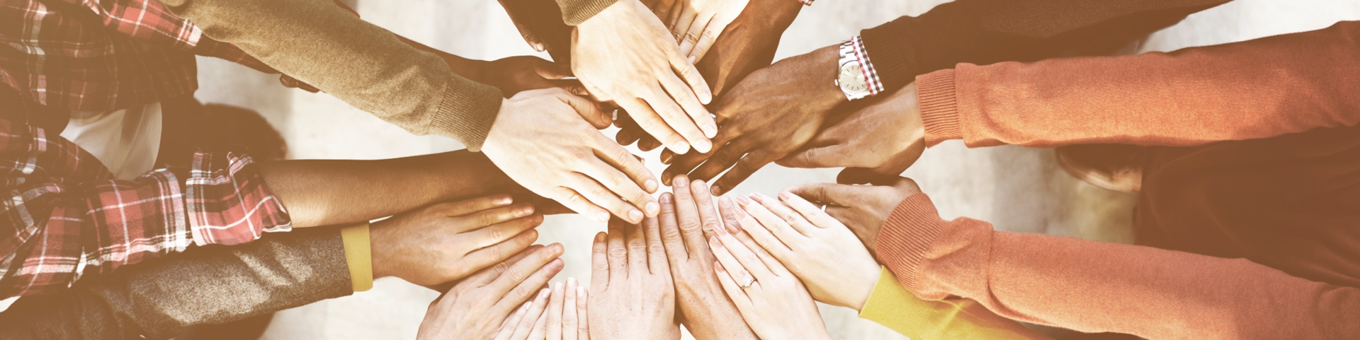 A group of peopling placing their hands together