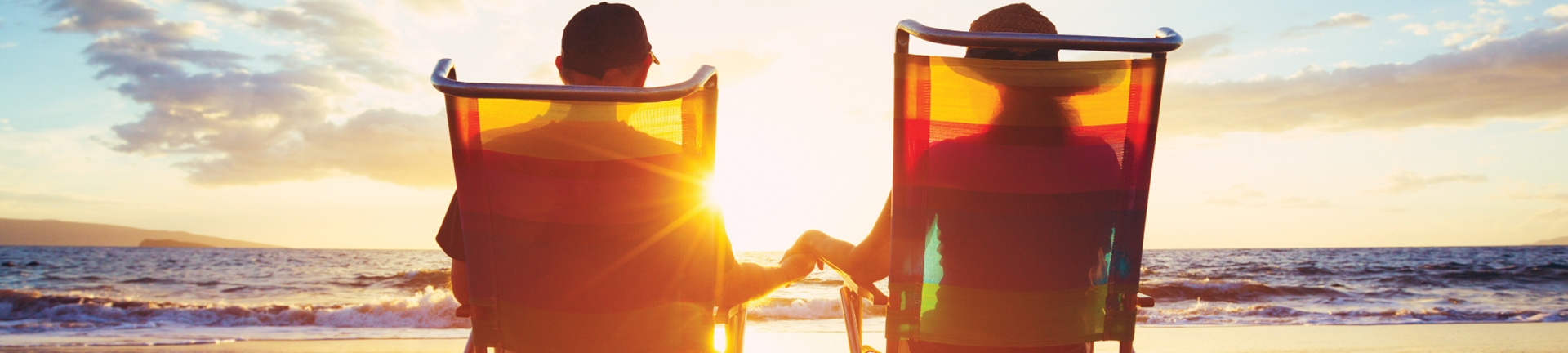 Couple sitting in chairs on a beach