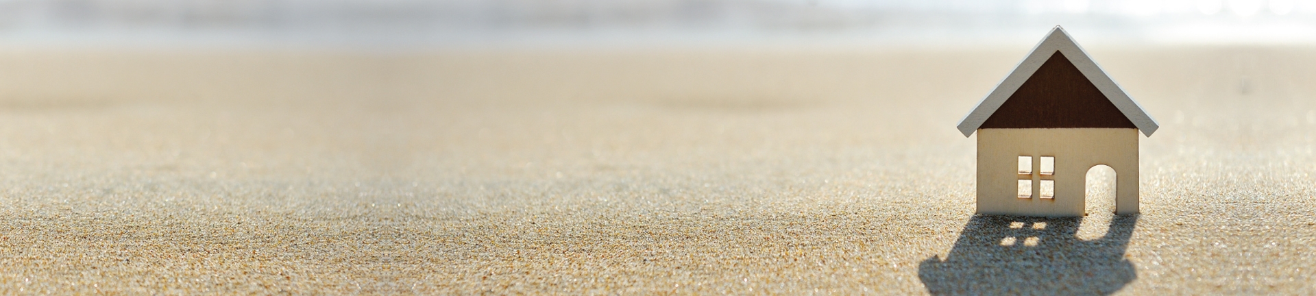 A toy house on a beach